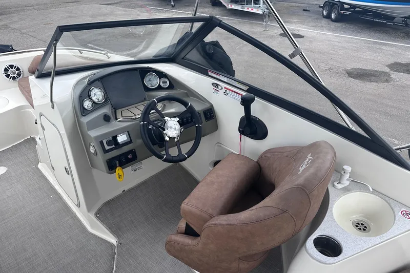 Slide: The Image of 2022 Stingray 201 DC boat interior with steering wheel and dashboard controls. - 11