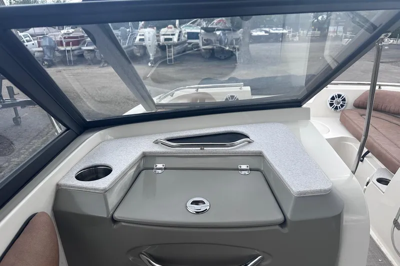 Slide: The Image of Interior view of 2022 Stingray 201 DC boat, featuring seating and storage compartments. - 17