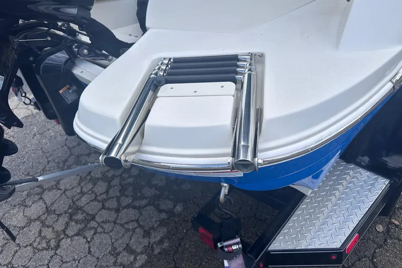 Slide: The Image of 2022 Stingray 201 DC boat with stainless steel swim ladder on trailer. - 3