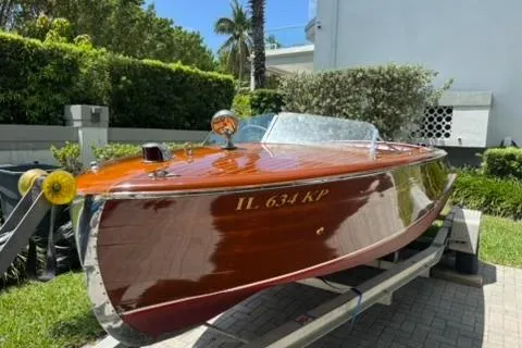 Slide: The Image of 1952 Chris-Craft 18 Runabout boat with polished wood finish on a trailer. - 10