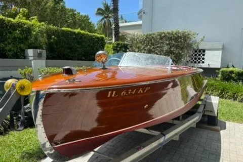 Slide: The Image of 1952 Chris-Craft 18 Runabout boat with polished wood finish on a trailer. - 11