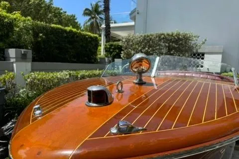 Slide: The Image of 1952 Chris-Craft 18 Runabout boat with polished wooden deck and chrome details. - 12
