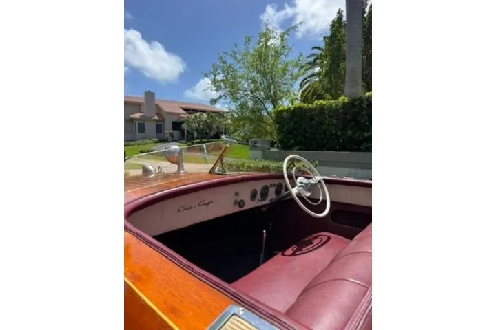 Slide: The Image of 1952 Chris-Craft 18 Runabout boat interior with red leather seats and classic steering wheel. - 15