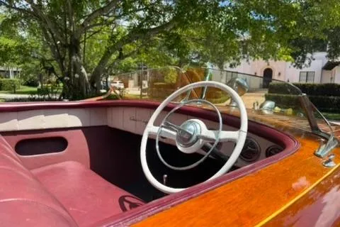 Slide: The Image of 1952 Chris-Craft 18 Runabout interior with classic wooden dashboard and red seating. - 17
