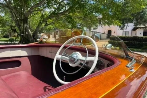 Slide: The Image of 1952 Chris-Craft 18 Runabout interior with classic wooden finish and vintage steering wheel. - 18