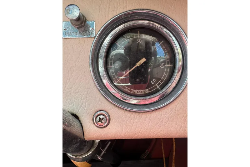 Slide: The Image of 1952 Chris-Craft 18 Runabout dashboard with vintage oil pressure gauge. - 21