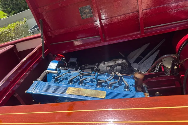 Slide: The Image of 1952 Chris-Craft 18 Runabout engine compartment with blue engine and red wood finish. - 25