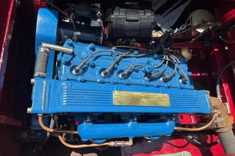 Slide: The Image of 1952 Chris-Craft 18 Runabout engine, blue with visible wiring and components. - 29