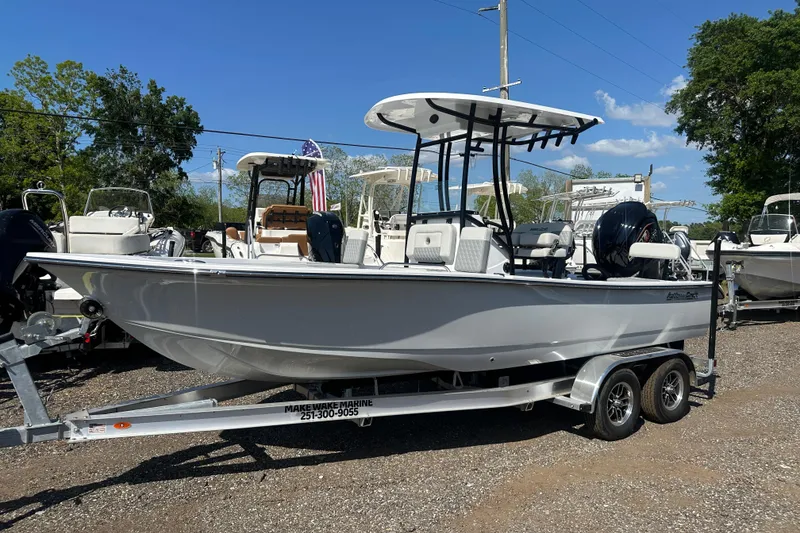The Image of 2026 Action Craft 22 Bay boat on trailer, displayed outdoors under clear blue sky. - 1