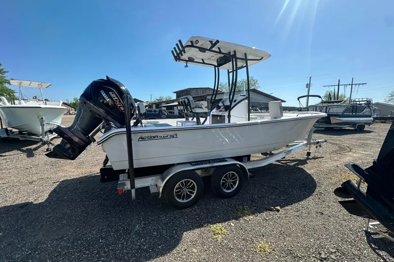 Slide: The Image of 2026 Action Craft 22 Bay boat on trailer, parked outdoors under clear sky. - 10