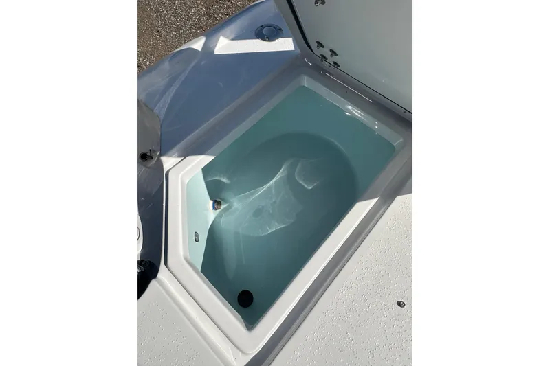 Slide: The Image of Livewell compartment on 2026 Action Craft 22 Bay boat, open lid, filled with water. - 17