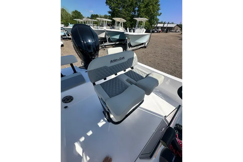 Slide: The Image of 2026 Action Craft 22 Bay boat with cushioned seating and outboard motor. - 19