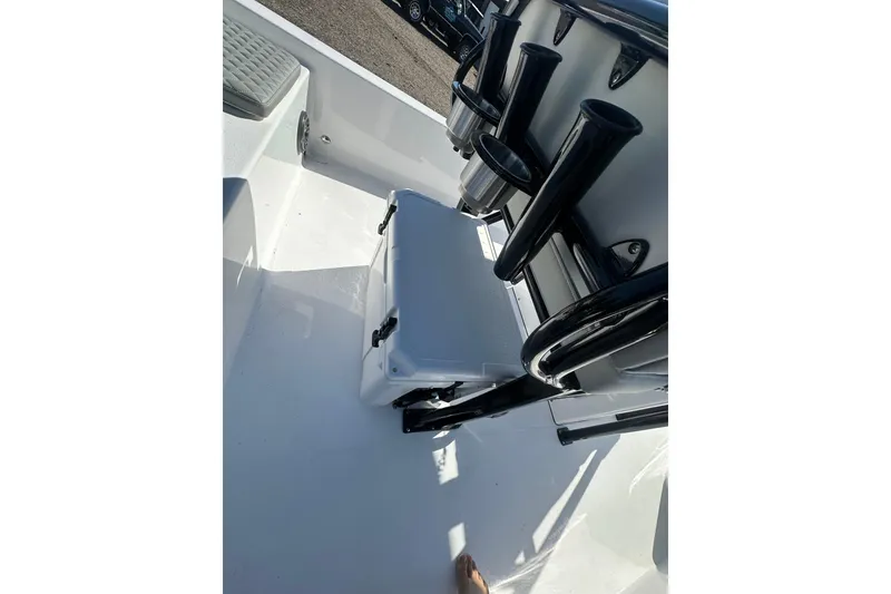 Slide: The Image of 2026 Action Craft 22 Bay boat interior with cooler and rod holders. - 22