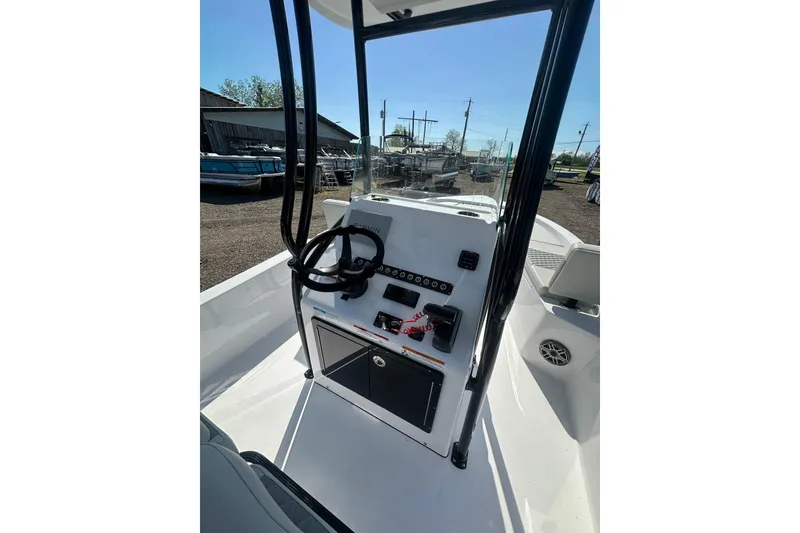 Slide: The Image of 2026 Action Craft 22 Bay boat console with steering wheel and controls. - 23