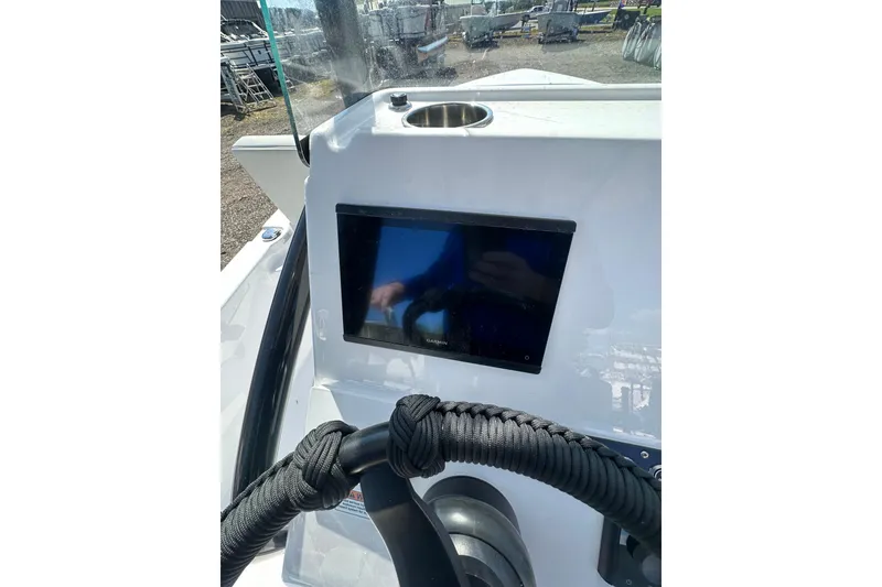 Slide: The Image of 2026 Action Craft 22 Bay boat dashboard with touchscreen display and steering wheel. - 26