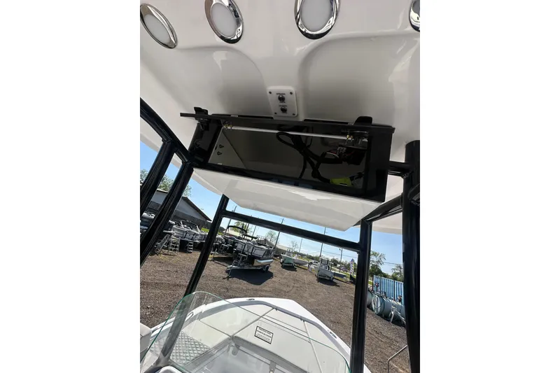 Slide: The Image of 2026 Action Craft 22 Bay boat interior with overhead console and sleek design. - 28