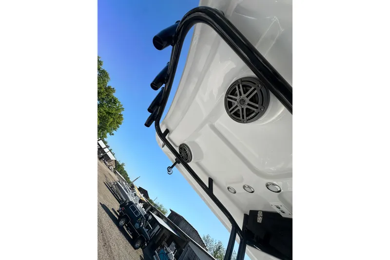 Slide: The Image of 2026 Action Craft 22 Bay boat underside with speaker and railing, clear blue sky background. - 30