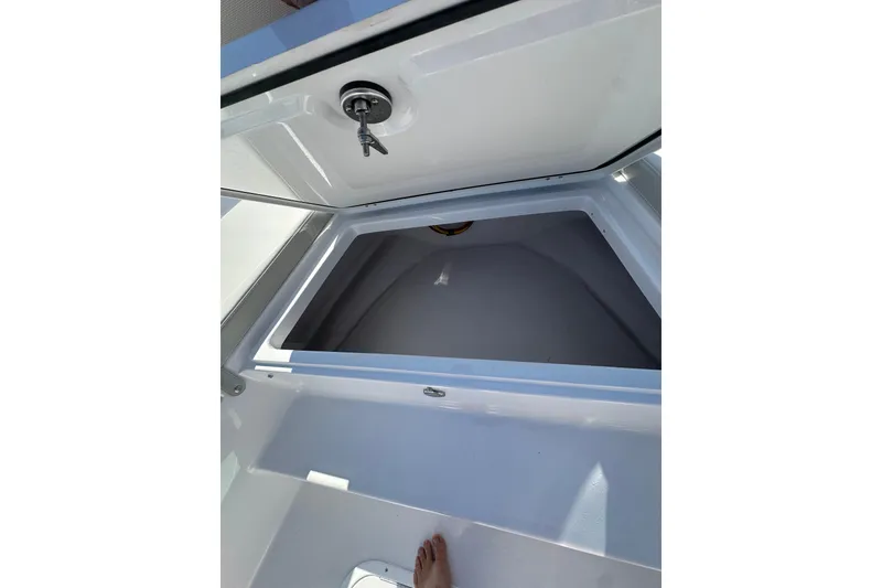 Slide: The Image of Open storage compartment on 2026 Action Craft 22 Bay boat, showcasing interior space. - 34