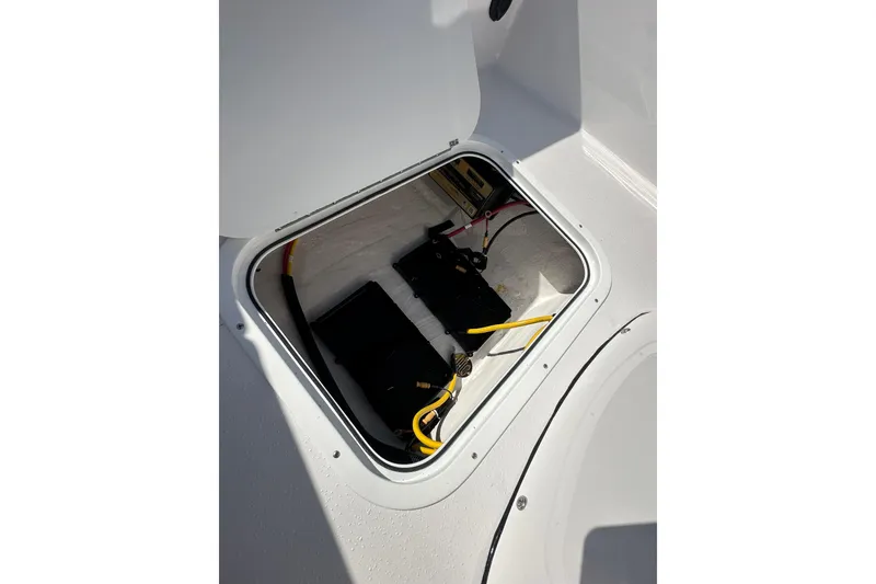Slide: The Image of Battery compartment of 2026 Action Craft 22 Bay boat with wiring visible. - 37