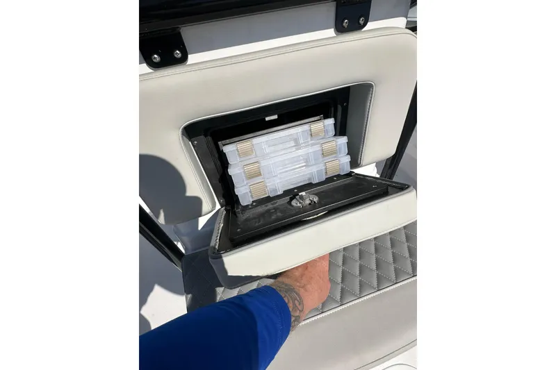 Slide: The Image of 2026 Action Craft 22 Bay boat seat storage with tackle boxes. - 39