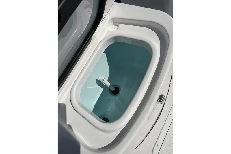 Slide: The Image of Livewell compartment on 2026 Action Craft 22 Bay boat, featuring a clean, white interior. - 40