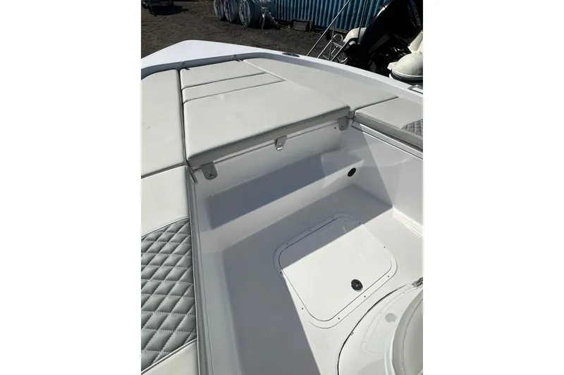 Slide: The Image of 2026 Action Craft 22 Bay boat interior with cushioned seating and storage compartment. - 47