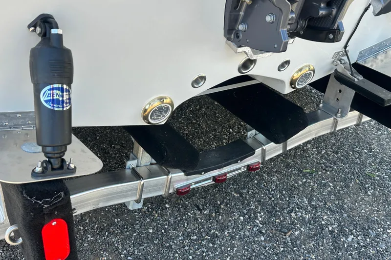 Slide: The Image of Rear view of 2026 Action Craft 22 Bay boat trailer with hydraulic components. - 6