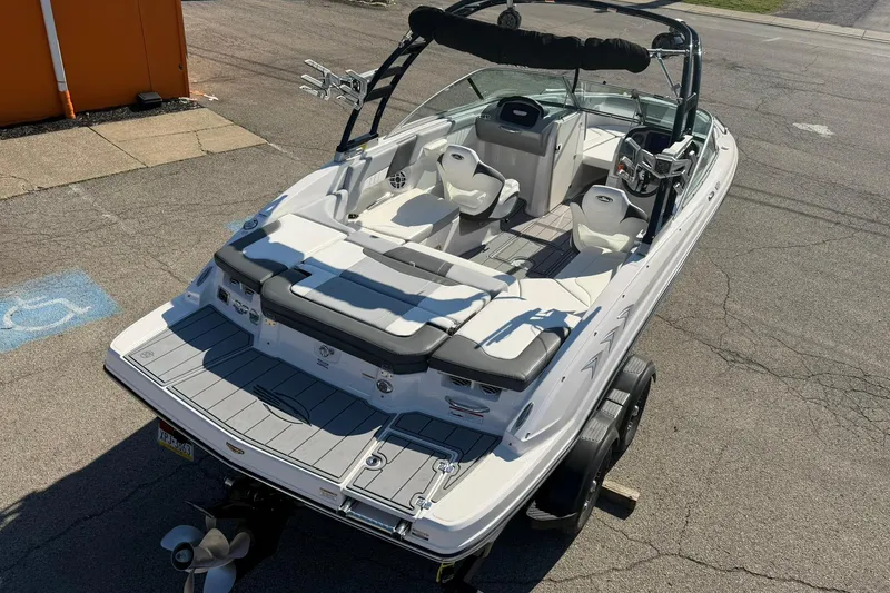 Slide: The Image of 2023 Chaparral 23 SSi boat with sleek interior and modern design on a trailer. - 4