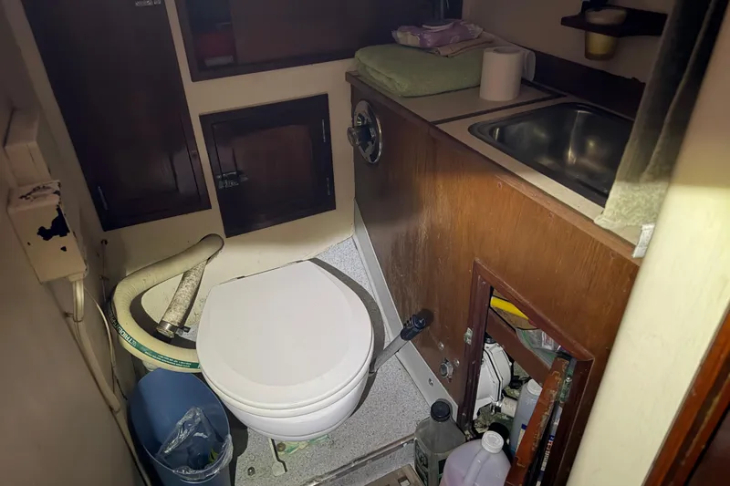 Slide: The Image of Hinckley Bermuda 40 yacht bathroom with toilet, sink, and storage cabinets, 1963 model. - 14