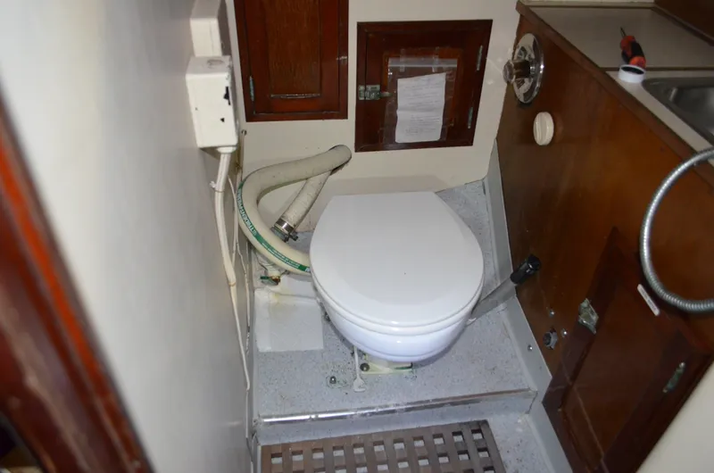 Slide: The Image of Interior of a 1963 Hinckley Bermuda 40 yacht with toilet and wood paneling. - 15