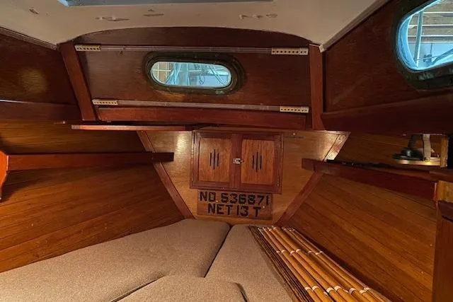 Slide: The Image of Interior of 1963 Hinckley Bermuda 40 sailboat with wooden paneling and cozy sleeping area. - 2