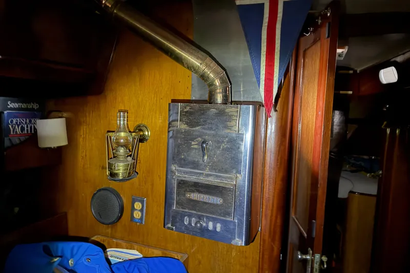 Slide: The Image of Interior of 1963 Hinckley Bermuda 40 yacht with vintage heater and nautical decor. - 21