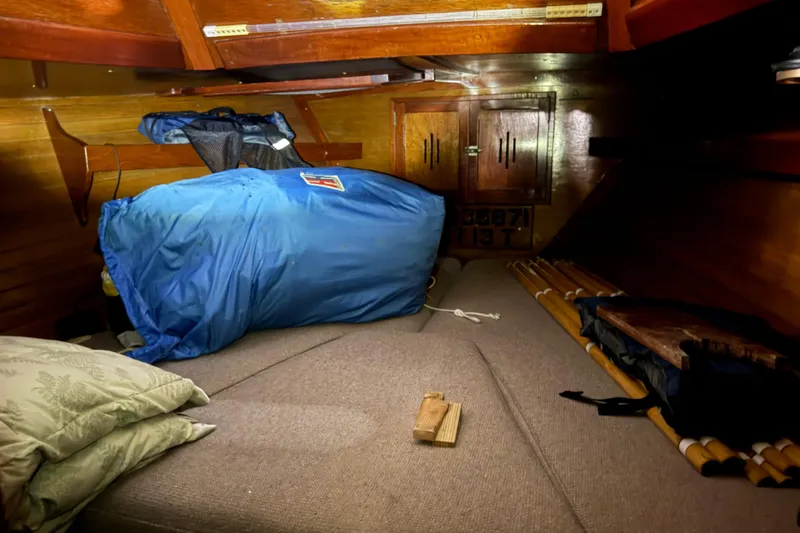 Slide: The Image of Interior cabin of a 1963 Hinckley Bermuda 40 sailboat with cushions and storage. - 3