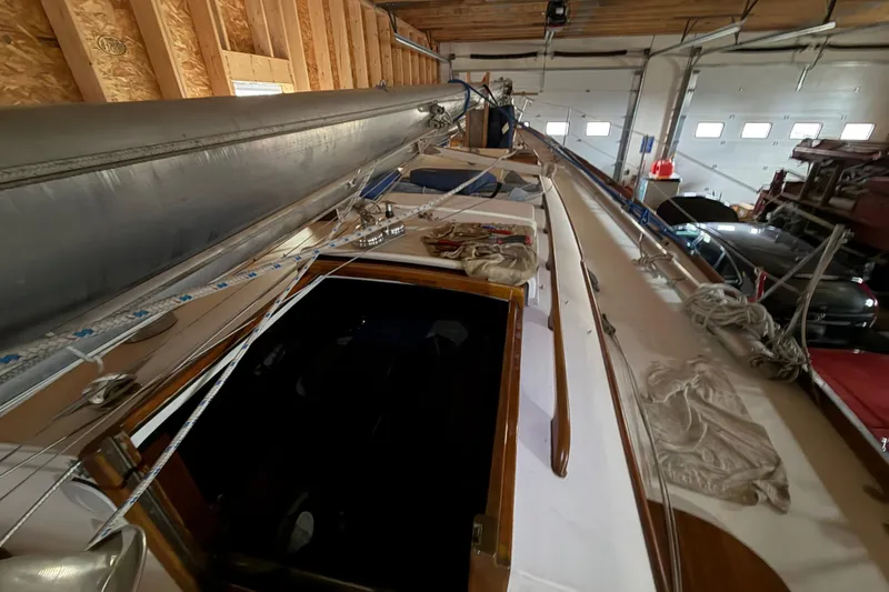 Slide: The Image of Hinckley Bermuda 40 sailboat from 1963 stored indoors, showcasing deck and rigging. - 42