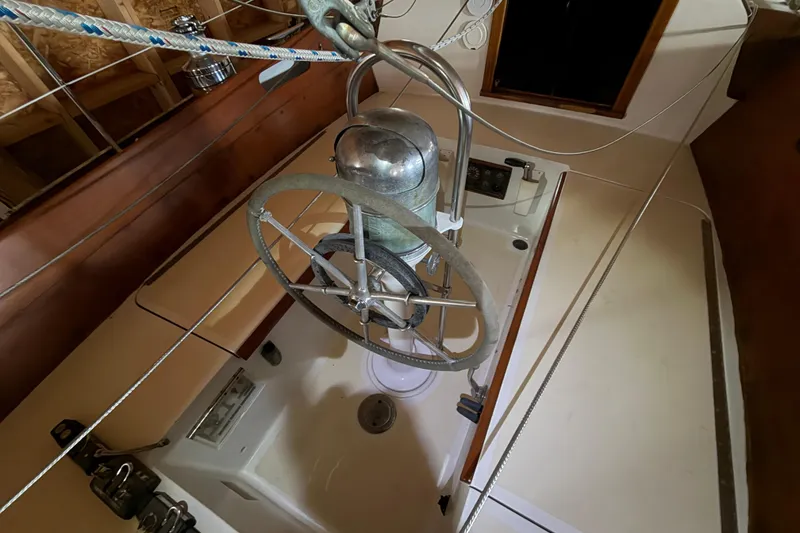 Slide: The Image of Interior view of a 1963 Hinckley Bermuda 40 sailboat cockpit with steering wheel. - 50