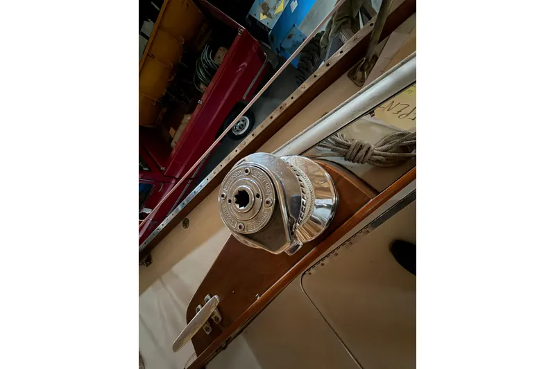 Slide: The Image of Winch on 1963 Hinckley Bermuda 40 sailboat deck, featuring polished metal and wood elements. - 52