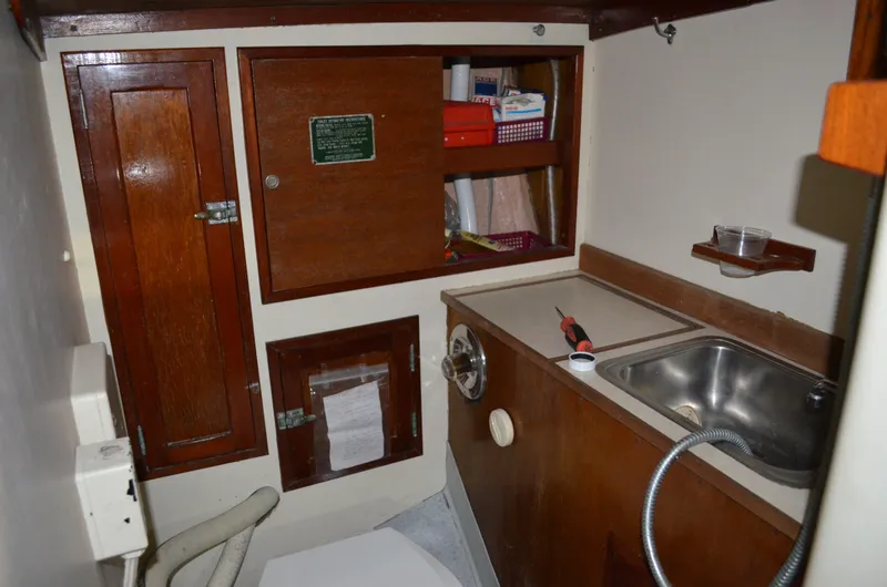 Slide: The Image of Interior of 1963 Hinckley Bermuda 40 yacht with wooden cabinets and sink. - 6