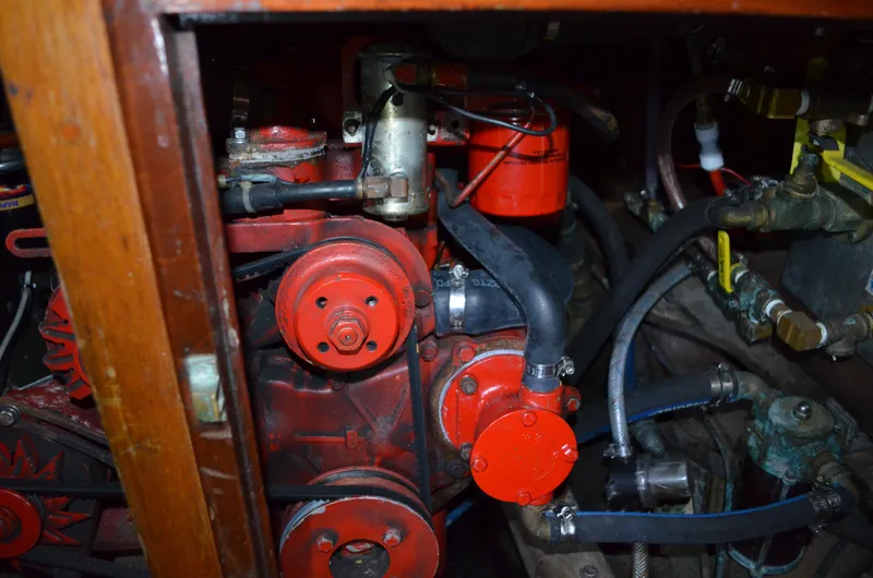 Slide: The Image of Engine compartment of a 1963 Hinckley Bermuda 40 sailboat, featuring red engine components. - 64