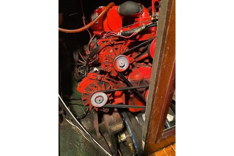 Slide: The Image of Engine of a 1963 Hinckley Bermuda 40 sailboat, featuring red components and belts. - 66