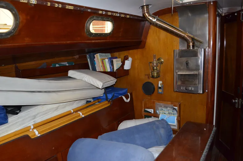 Slide: The Image of Interior of a 1963 Hinckley Bermuda 40 yacht with wood paneling and stove. - 9