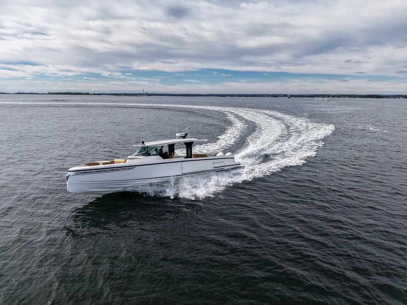 Slide: The Image of A Saxdor 400 GTS boat speeds across the water, leaving a white wake behind. - 29