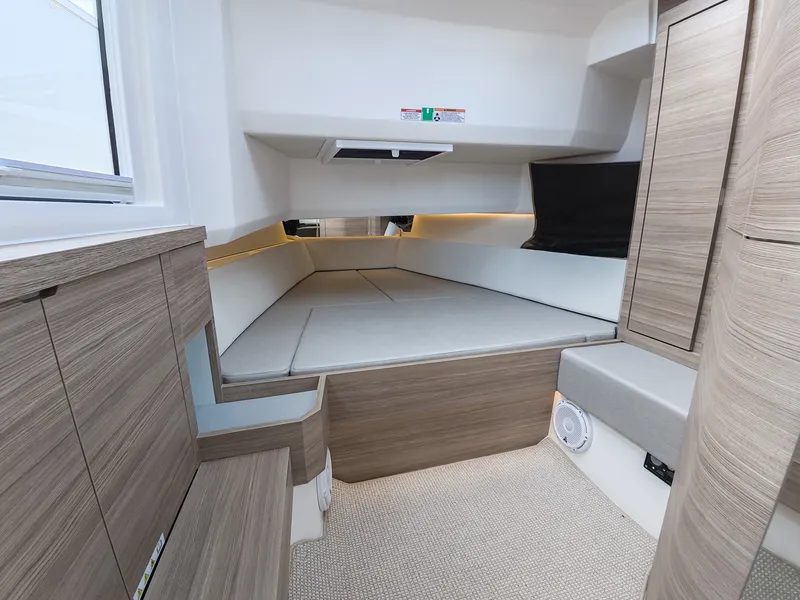 Slide: The Image of Interior of a modern cabin with wood paneling and cushioned seating. - 24