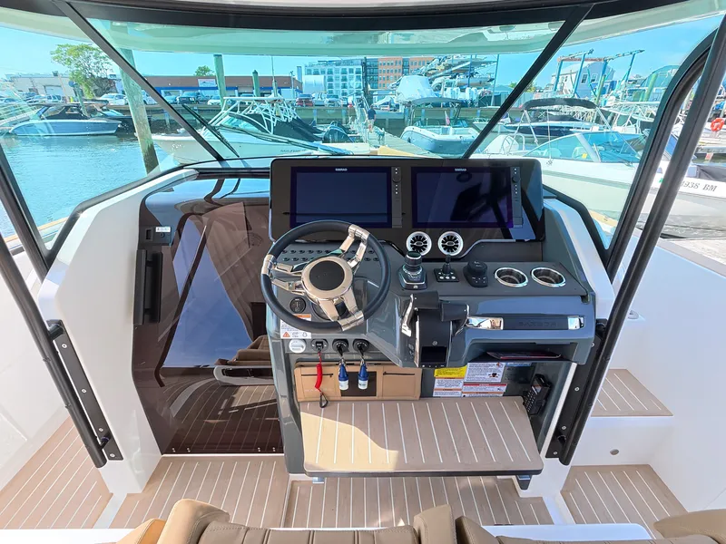 Slide: The Image of The 2027 Saxdor 400 GTS cockpit features a modern helm with multiple screens and instruments. - 21