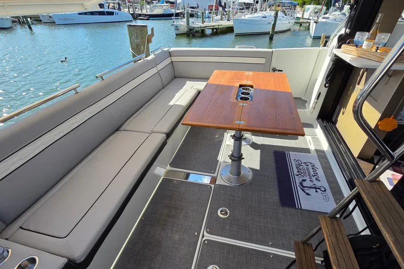 Slide: The Image of Luxurious seating area on 2024 Jeanneau NC Weekender 1295 Fly yacht, docked at marina. - 11