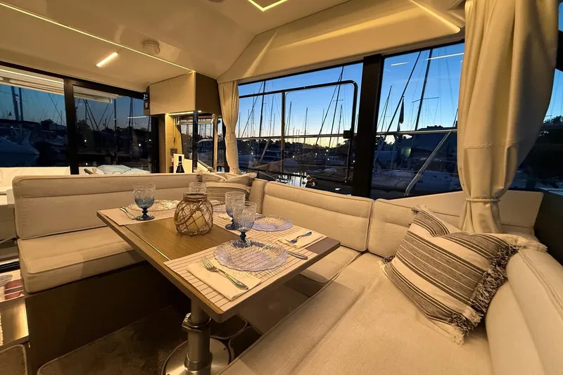 Slide: The Image of Luxurious interior of 2024 Jeanneau NC Weekender 1295 Fly at sunset, featuring elegant dining setup. - 17