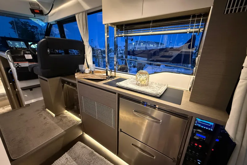 Slide: The Image of Luxurious interior of 2024 Jeanneau NC Weekender 1295 Fly yacht, featuring modern kitchen amenities. - 19
