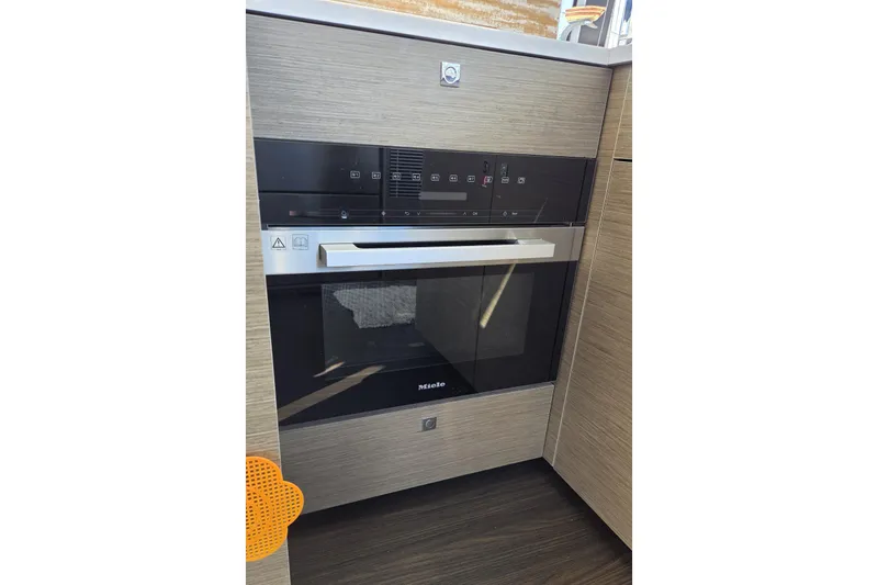 Slide: The Image of Modern kitchen oven in 2024 Jeanneau NC Weekender 1295 Fly yacht. - 21