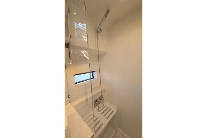Slide: The Image of 2024 Jeanneau NC Weekender 1295 Fly bathroom with modern shower and sleek design. - 29