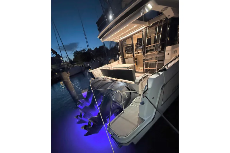 Slide: The Image of 2024 Jeanneau NC Weekender 1295 Fly yacht docked at night with illuminated water. - 31
