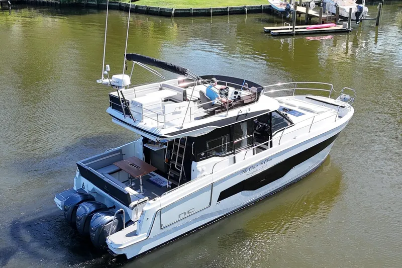 Slide: The Image of 2024 Jeanneau NC Weekender 1295 Fly cruising on a calm river. - 5